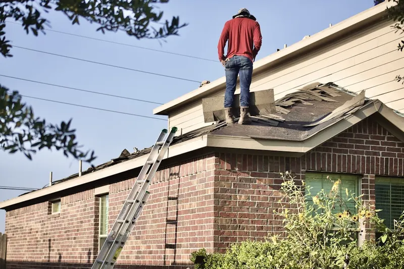 Professional roofer working on a residential roof in Jbsa Lackland